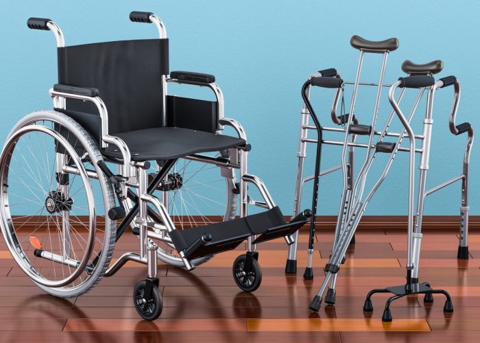 Wheelchair, walking frame and crutches on the wooden floor in the room, 3D rendering